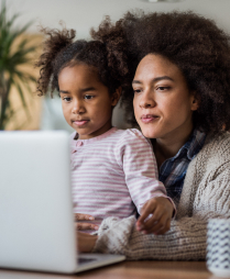 Mother with daughter looking at computer